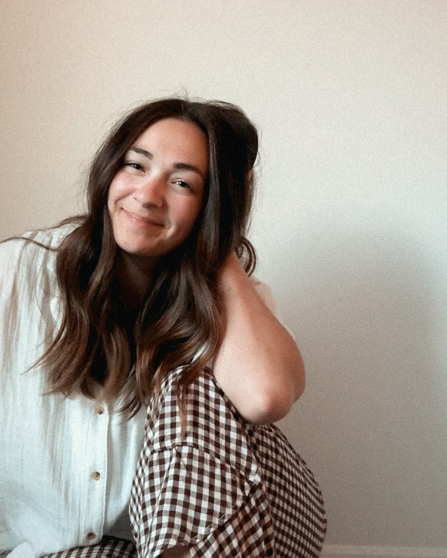 Alexa, founder of Gathered Home & Kin, sitting on the floor at home